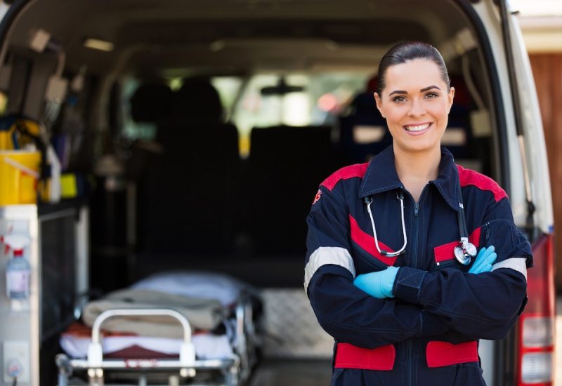 Emergency medical worker in front of EMS van